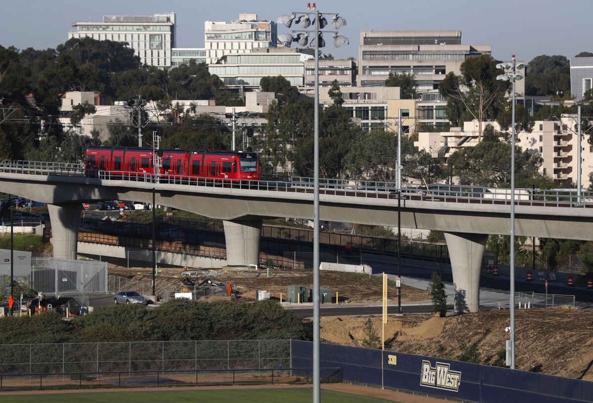  A trolley on the MTS Mid-Coast Extension Blue Line heads away from the UC San Diego.