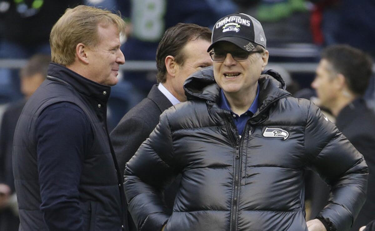 Seattle Seahawks owner Paul Allen, right, speaks with NFL commissioner Roger Goodell before last week's NFC championship game against the San Francisco 49ers. Convincing Allen to buy the Seahawks wasn't an easy sell.