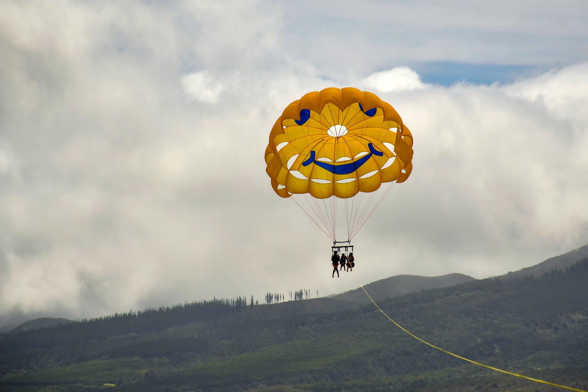 Parasailing is popular off the Ka'anapali coastal resort area of West Maui.