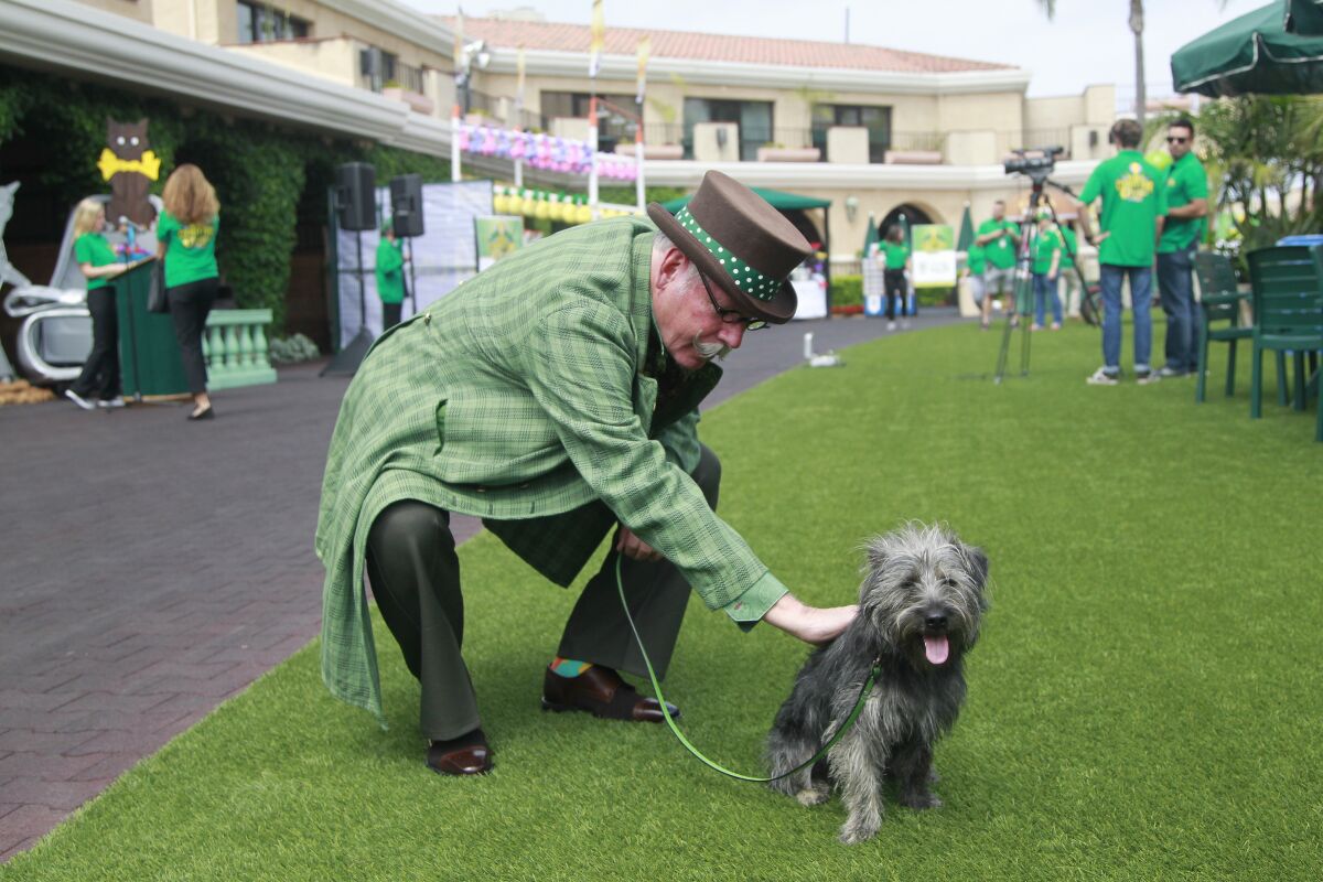 Dressed as the Wizard of Oz, Oscar Diggs pets "Toto" during the press preview on Tuesday for this year's "Wizard of Oz"-themed San Diego County Fair at the Del Mar Fairgrounds.