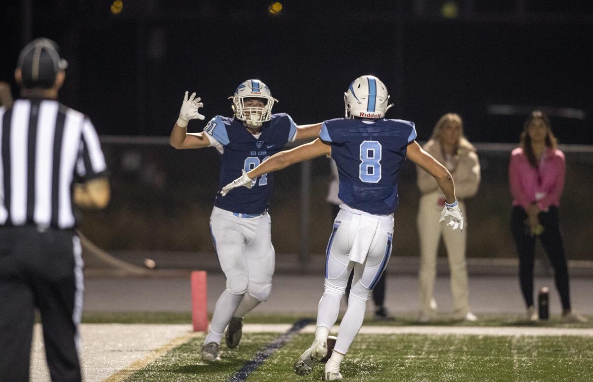 Corona del Mar's Russell Weir (8) celebrates a touchdown with Zach Giuliano (81) during a game against Los Alamitos.