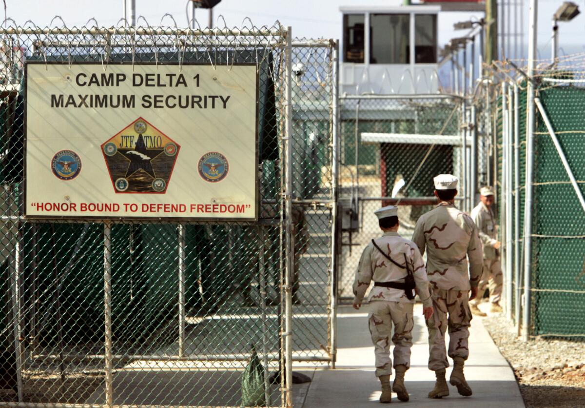 U.S. military guards walk within Camp Delta military-run prison at the Guantanamo Bay U.S. Naval Base in Cuba.