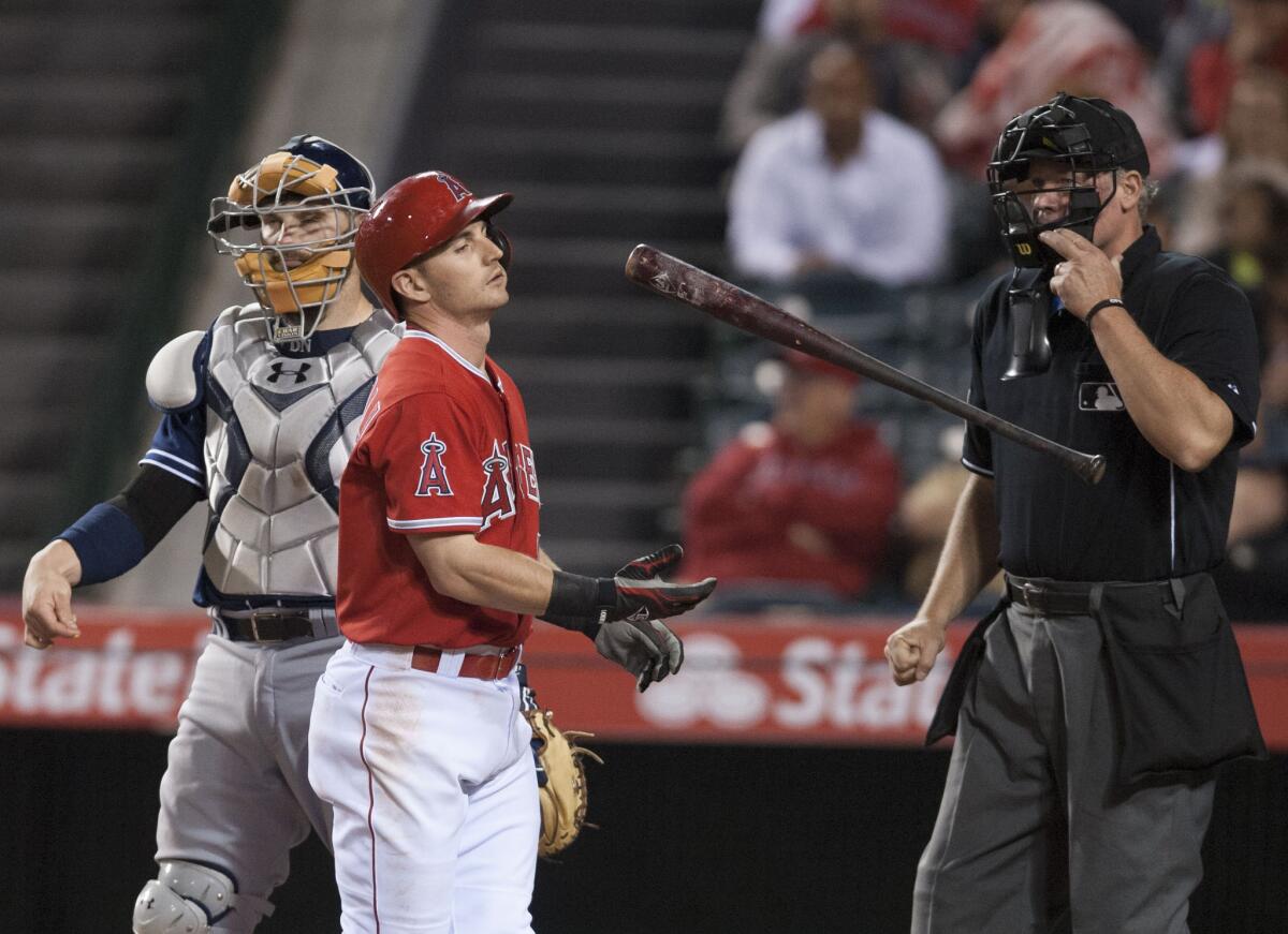 Angels second baseman Johnny Giavotella flips his bat after striking out in the eighth inning.