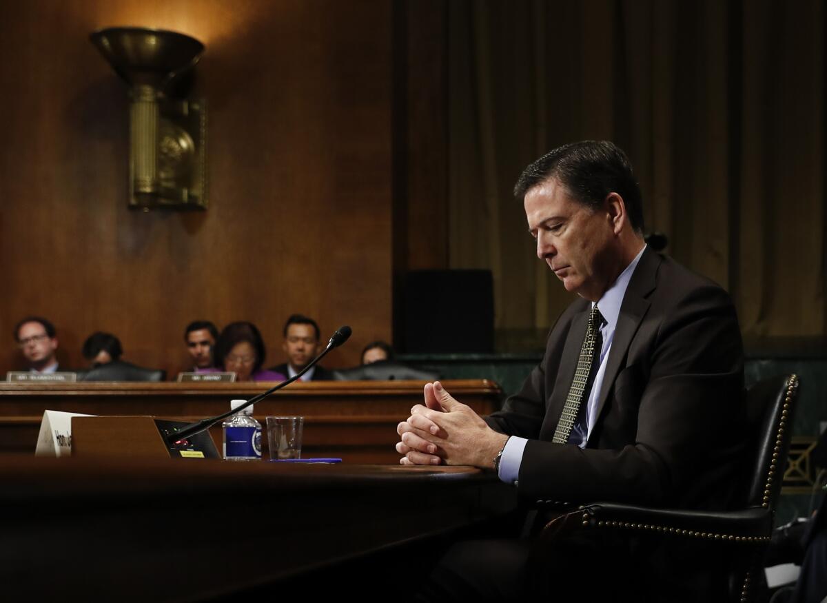 Then-FBI Director James B. Comey pauses as he testifies at a Senate Judiciary Committee hearing on May 3.