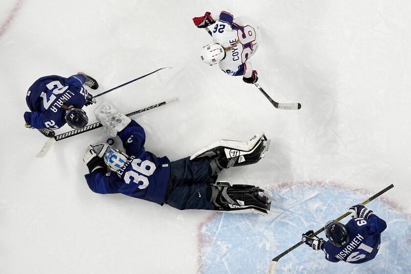 Finland goalkeeper Anni Keisala (36) covers up puck as Julia Liikala (27) and United States' Kendall Coyne Schofield (26) watch for the rebound during a preliminary round women's hockey game at the 2022 Winter Olympics, Thursday, Feb. 3, 2022, in Beijing. (AP Photo/Petr David Josek)
