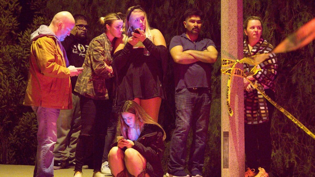 Friends and family members wait for news following a mass shooting that left multiple casualties at Borderline Bar & Grill.
