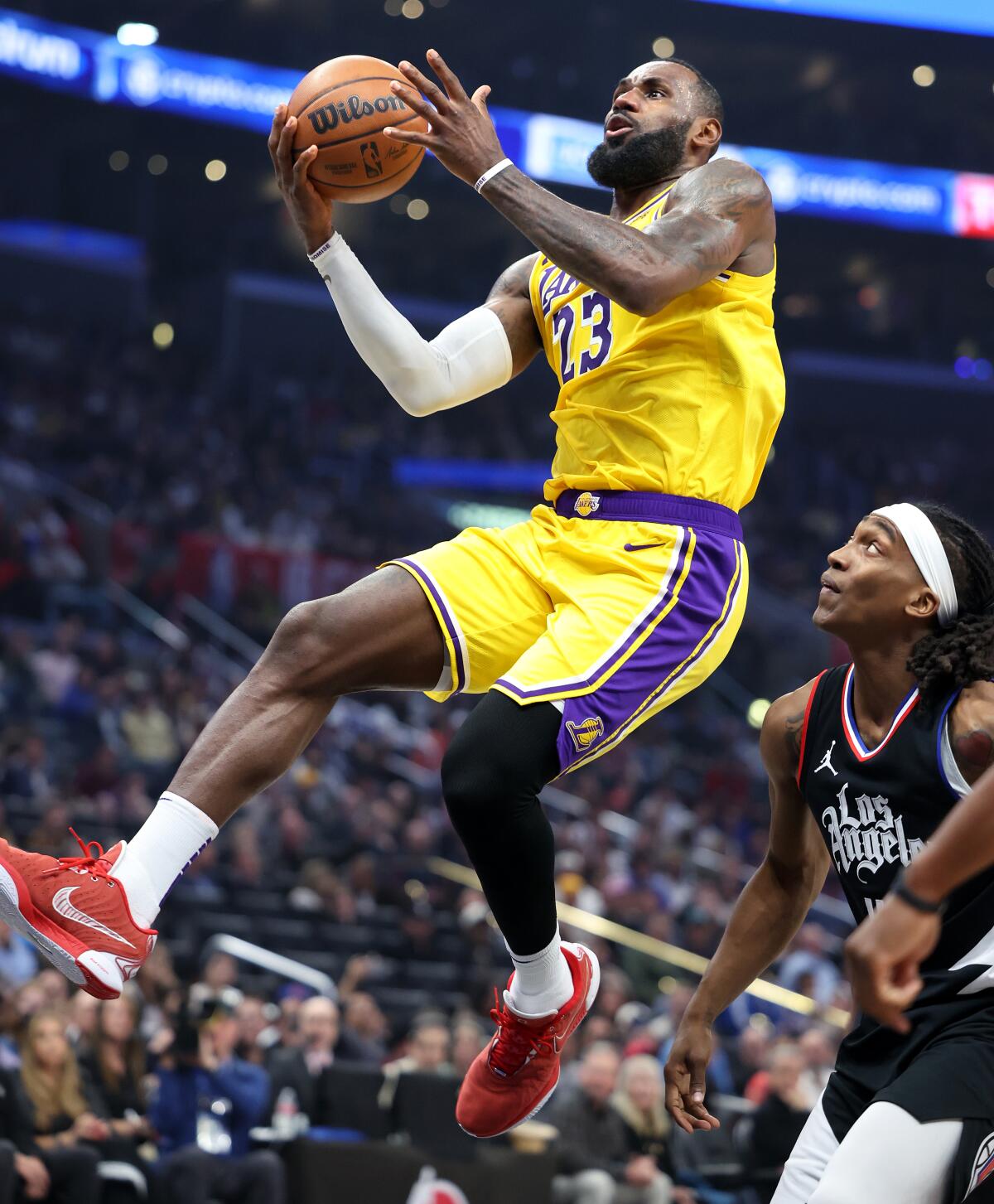 The Lakers' LeBron James drives past the Clippers' Terance Mann in the second quarter at Crypto.com Arena.