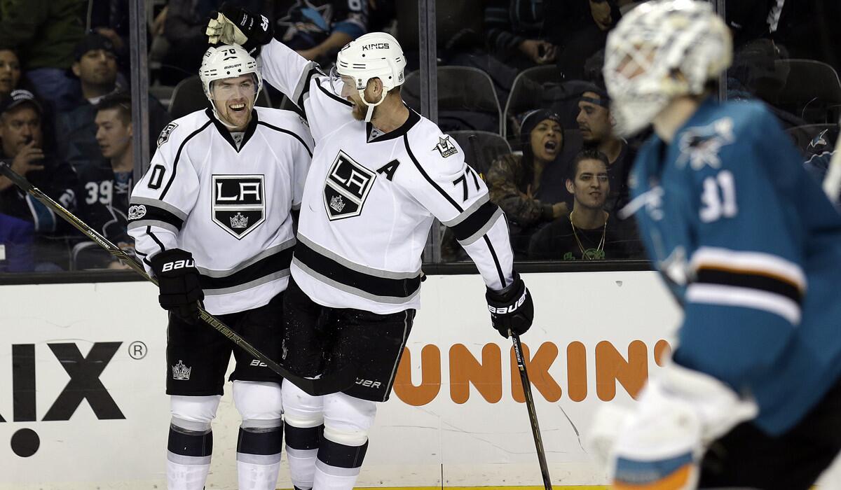 The Kings' Tanner Pearson, left, is congratulated by Jeff Carter (77) after scoring the game-winning goal against the San Jose Sharks during overtime on Tuesday.