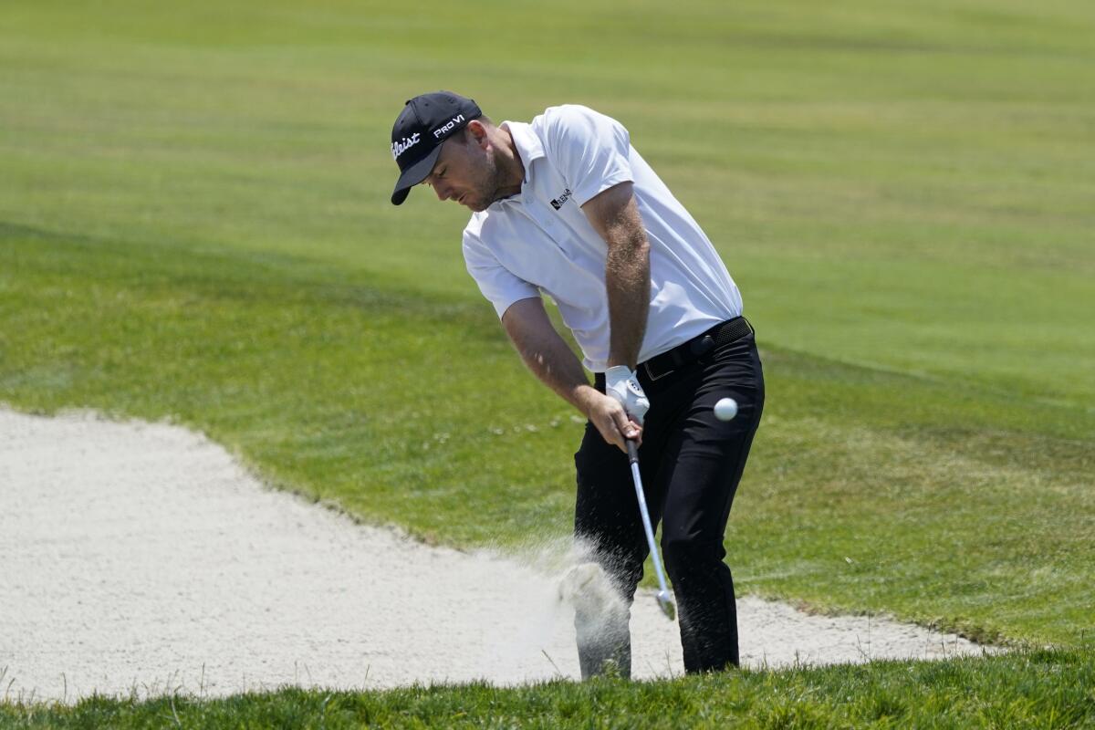 Russell Henley hits from a 17th-hole fairway bunker during the first round of the U.S. Open.