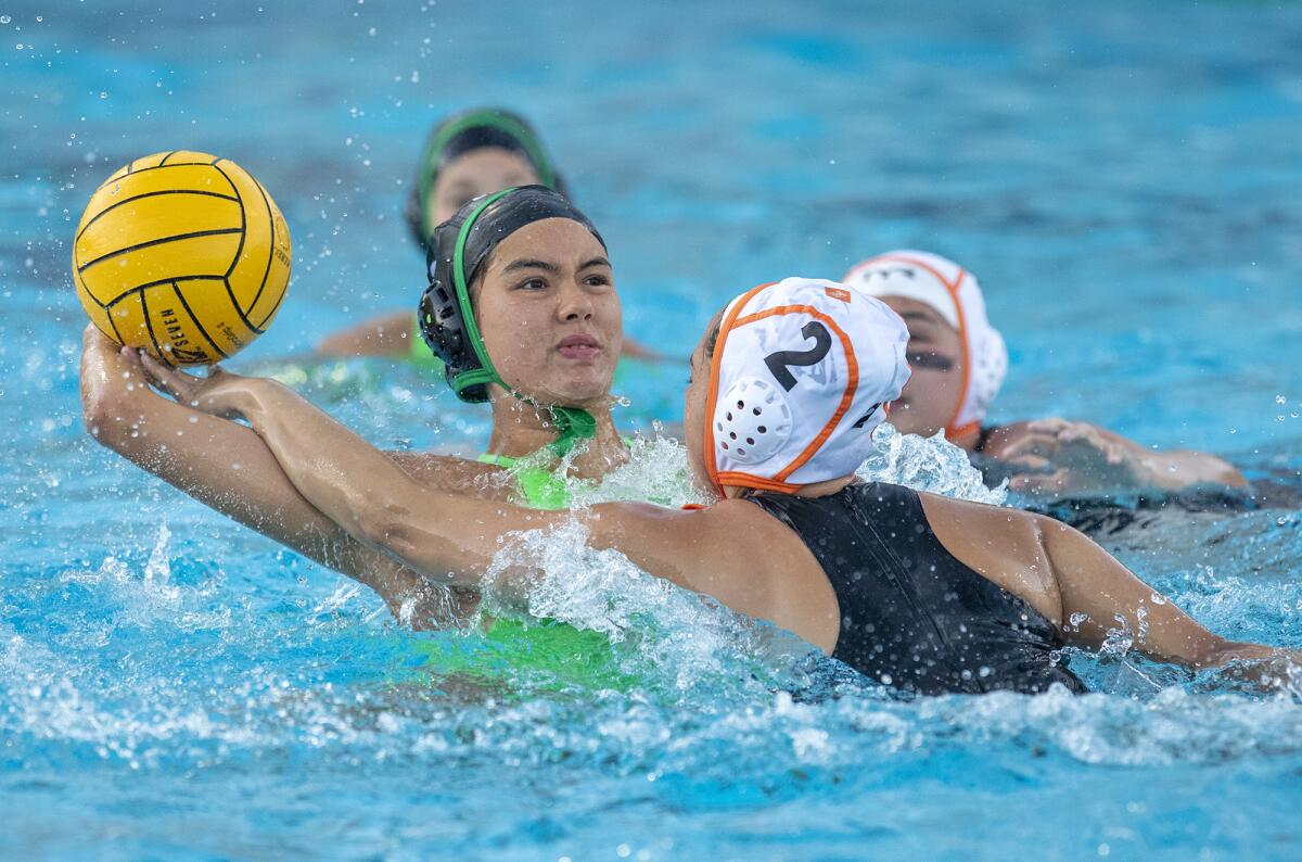 Costa Mesa's Michelle Kiefer takes a shot under pressure from Los Amigos' Marliyn Castillo in the first round of the CIF Southern Section Division 5 playoffs at home Tuesday.