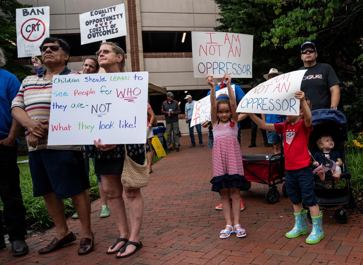 White children hold up signs reading "I Am Not an Oppressor" among other protesters.