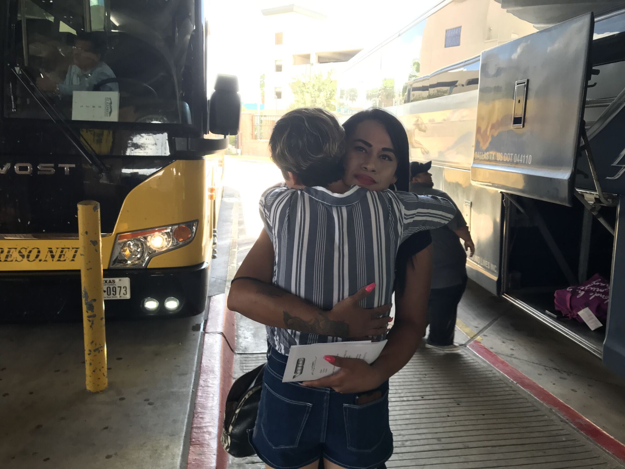 After being granted asylum, Mayela Villegas hugs Dani Marrero Hi before boarding a bus for Houston.