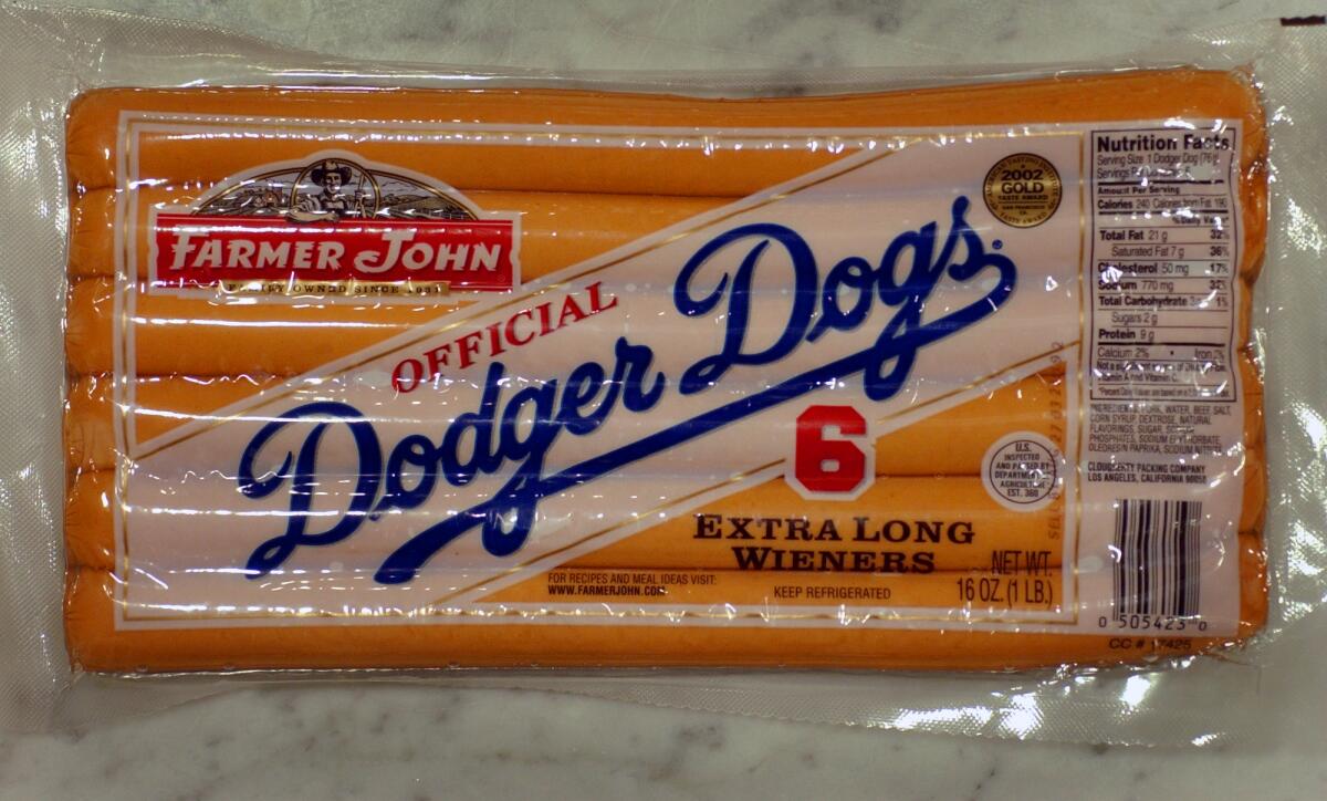 A package of hot dogs has the Farmer John logo and "Official Dodger Dogs: 6 Extra Long Wieners."
