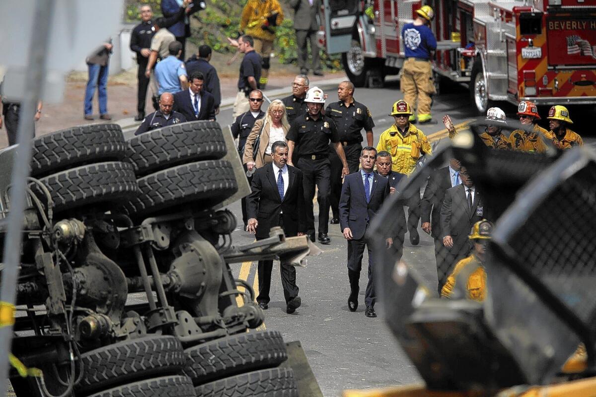 LAPD Chief Charlie Beck, left, and Los Angeles Mayor Eric Garcetti stand at the scene of a fatal collision involving an LAPD officer in Beverly Hills.