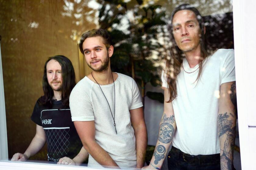 Incubus members Mike Einziger, left, and Brandon Boyd, right, with Zedd at Zedd's home in Los Angeles.
