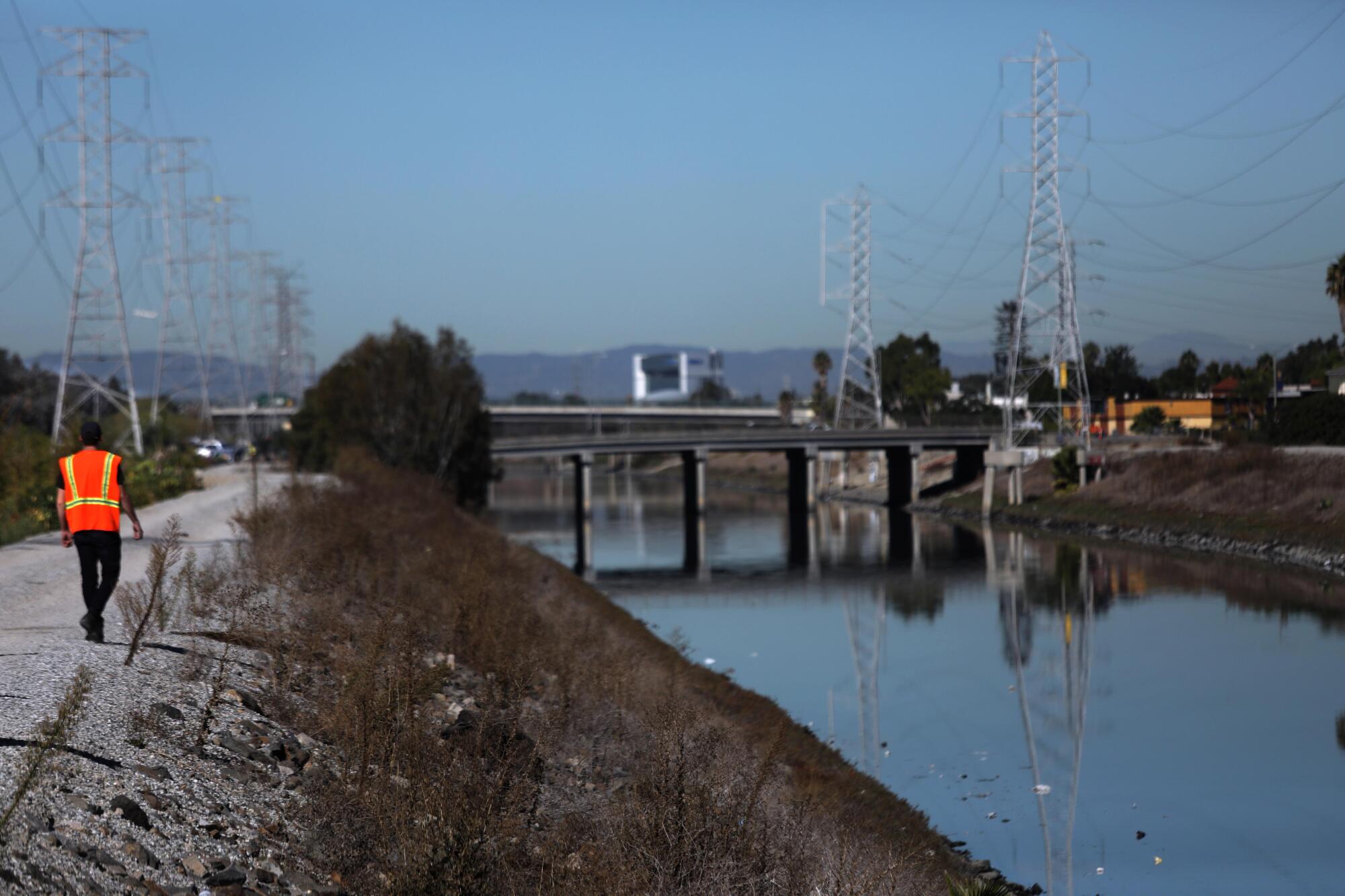 A worker walks along the Dominguez Channel.