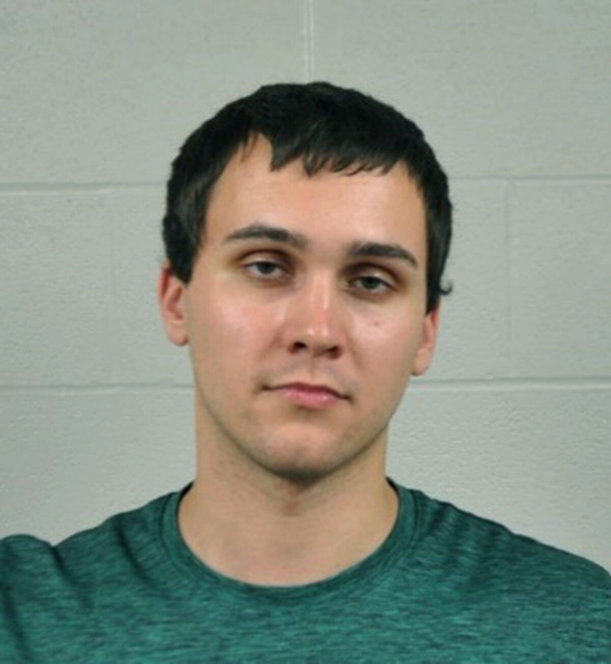 A young white man in a jail booking photo