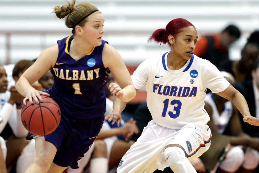 Albany guard Erin Coughlin drives against Florida guard Cassie Peoples during the first half Friday.