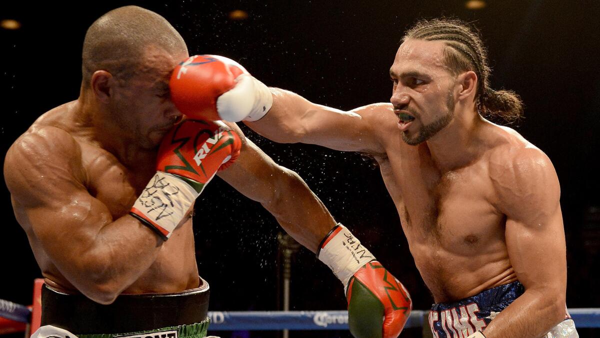 Keith Thurman, right, punches Leonard Bundu during a bout at the MGM Grand Garden Arena in Las Vegas on Dec. 13, 2014. Thurman won by unanimous decision.