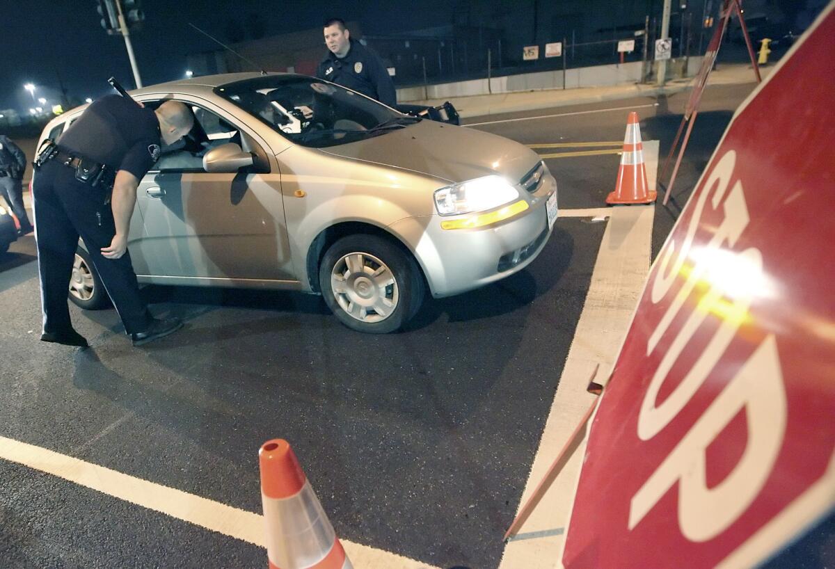 File Photo: Glendale police officers talk to a driver at a DUI checkpoint on Los Feliz Blvd. at San Fernando Rd. in January 2009.