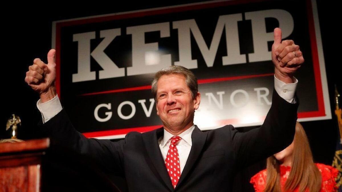 Brian Kemp gives a thumbs-up to supporters at an election-night party in Athens, Ga.