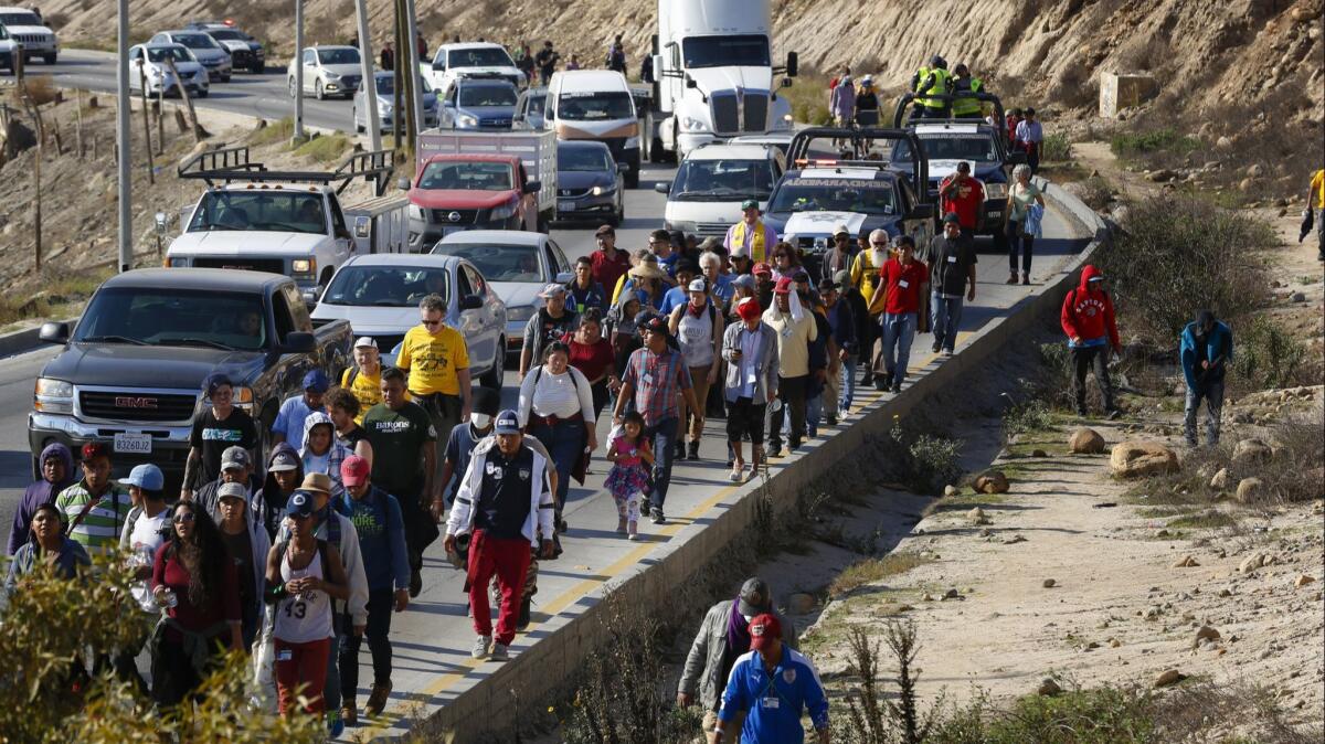 A group of about 50 migrants walked from a Mexican immigration office to the U.S. Consulate office in Tijuana to deliver a letter asking U.S. officials to speed up the asylum process.