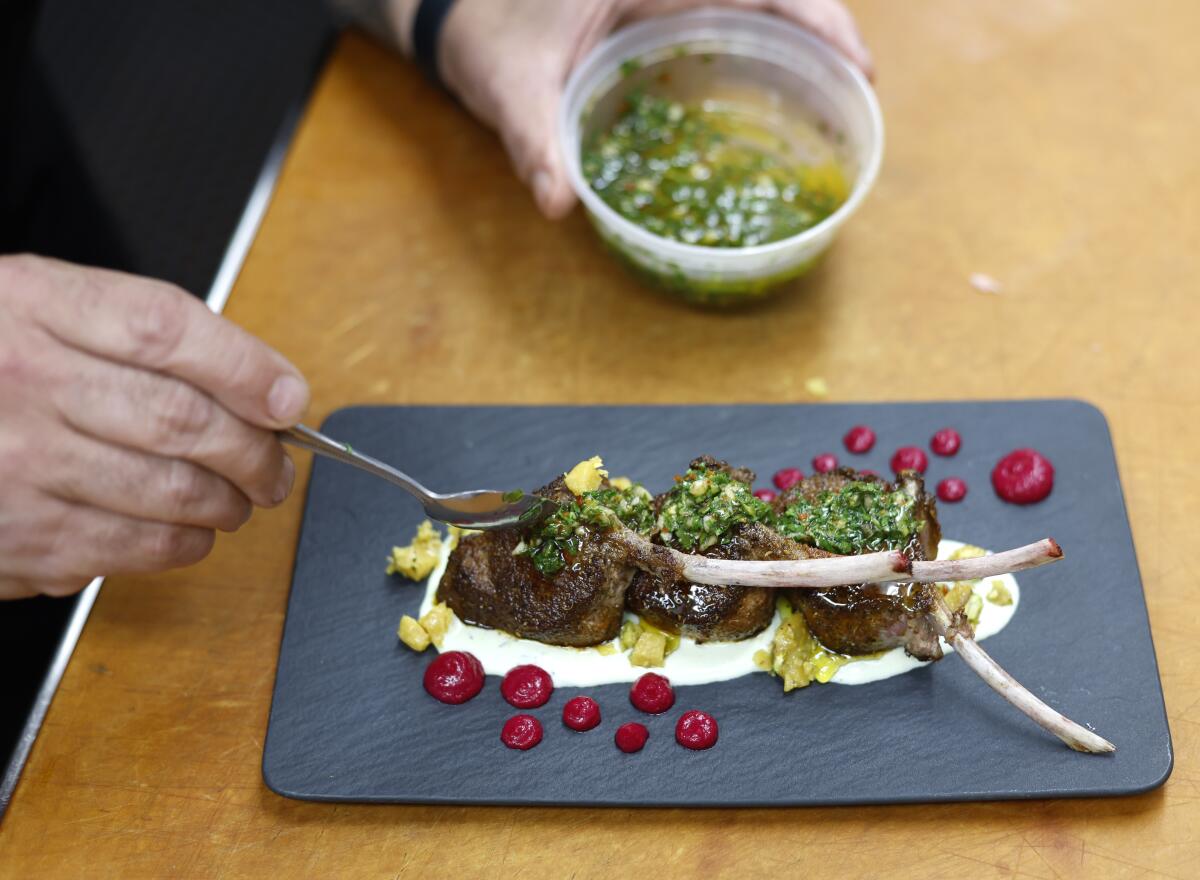 Chimichurri sauce is added atop grilled Moroccan lamb chops.