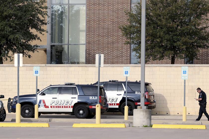 FILE - Arlington, Texas, police investigate a shooting at Lamar High School in Arlington, March 20, 2023. A 16-year-old who opened fire at the Dallas-area school earlier this year, killing one student and injuring another, was sentenced Thursday, Sept. 21, to 40 years in prison for capital murder and attempted capital murder, prosecutors said. (Amanda McCoy/Star-Telegram via AP, File)