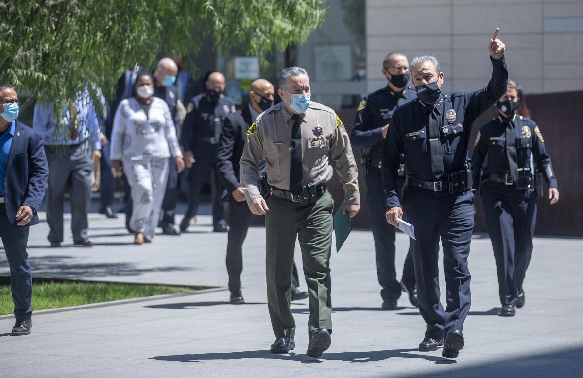 L.A. County Sheriff Alex Villanueva and LAPD Chief Michel Moore in masks