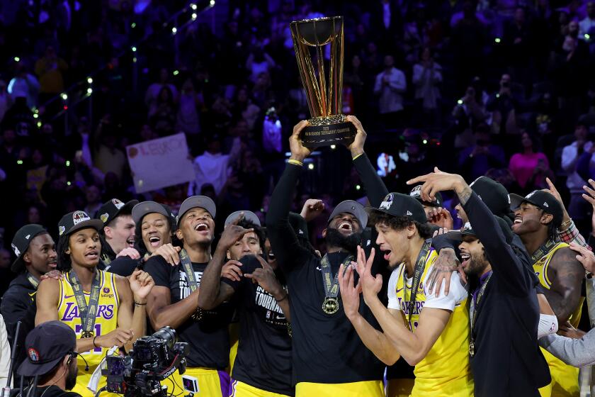 LAS VEGAS, NEVADA - DECEMBER 09: LeBron James #23 of the Los Angeles Lakers hoist the trophy with his teammates after winning the championship game of the inaugural NBA In-Season Tournament at T-Mobile Arena on December 09, 2023 in Las Vegas, Nevada. NOTE TO USER: User expressly acknowledges and agrees that, by downloading and or using this photograph, User is consenting to the terms and conditions of the Getty Images License Agreement. (Photo by Ethan Miller/Getty Images)