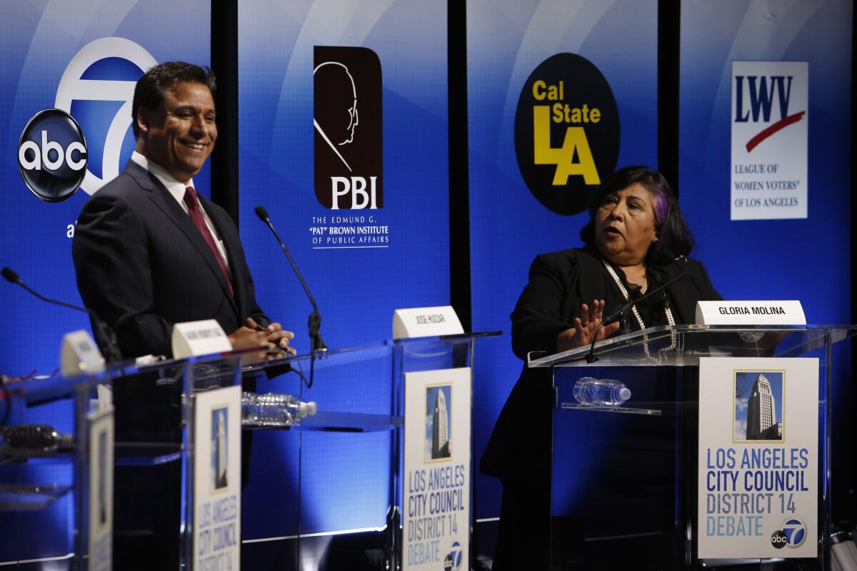 Former L.A. County Supervisor Gloria Molina, right, debates L.A. City Councilman Jose Huizar, left, for the City Council District 14 seat at the Student Union Theatre at Cal State L.A. on Feb. 18.