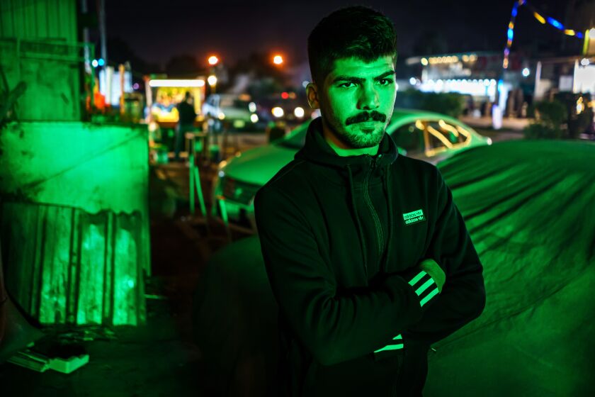 BAGHDAD, IRAQ -- NOVEMBER 24, 2021: Hussein Shumari, 25, poses for a portrait near his home that he vacated in Baghdad, Iraq, Wednesday, Nov. 24, 2021. Shumarir eturned to Baghdad after three weeks of trying to enter Europe via Belarus. Shumari borrowed thousands of dollars for the passage into Europe. Now back in Baghdad, he has no way to pay the money back. (MARCUS YAM / LOS ANGELES TIMES)