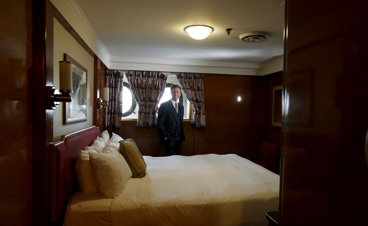 Woods, a principal of a real estate development company called Urban Commons, walks through a state room aboard Queen Mary