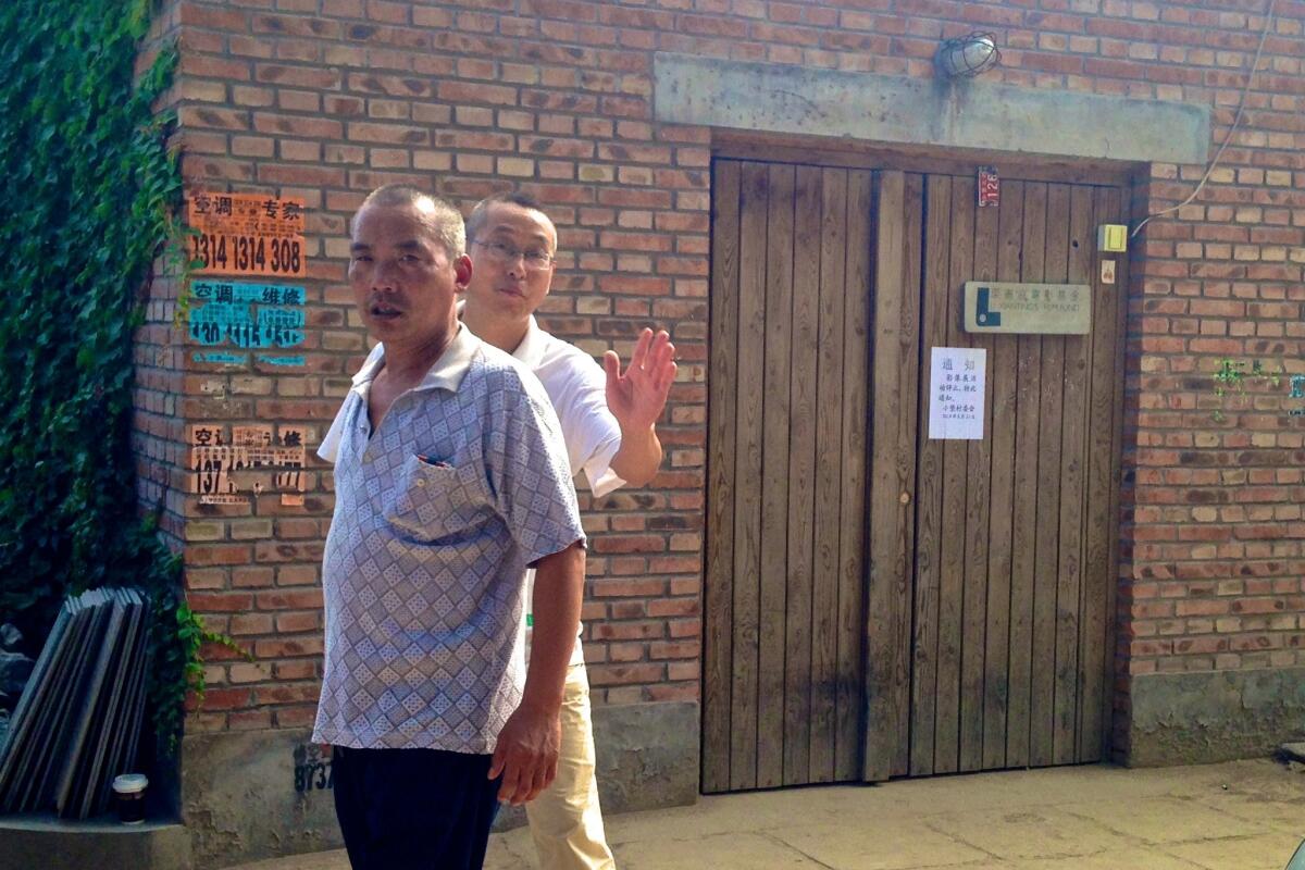 Men work to prevent would-be filmgoers from entering the site of Beijing Independent Film Festival after it was shut down.