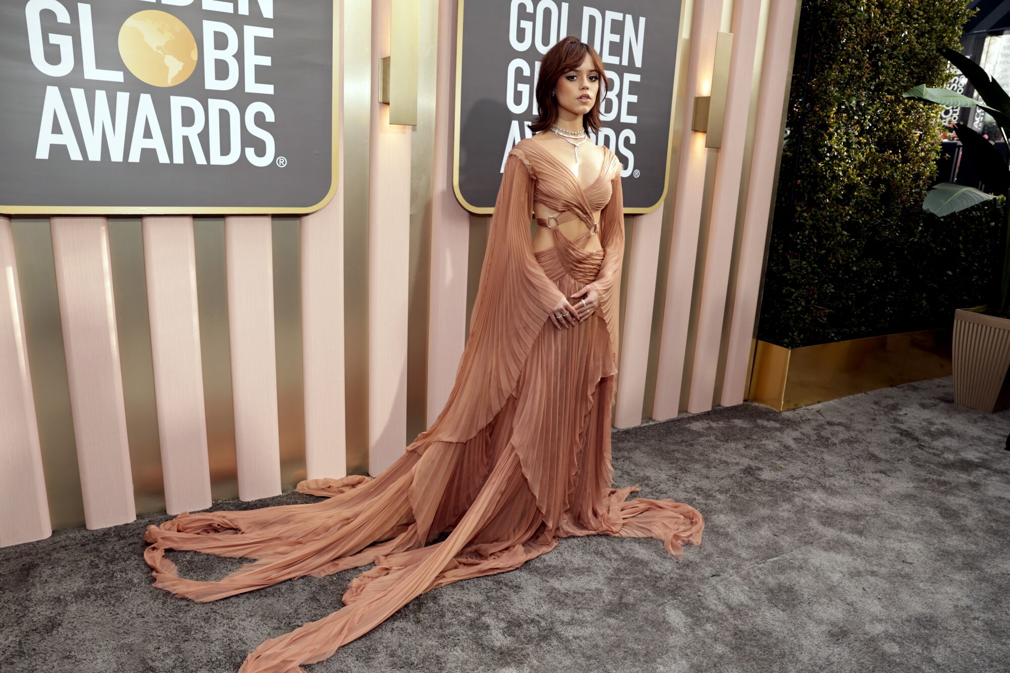 Jenna Ortega poses at the Golden Globes in a Gucci gown