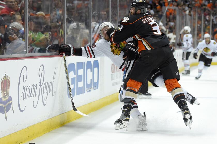 Ducks defenseman Clayton Stoner puts a hit on Blackhawks forward Bryan Bickell during the first period of Game 1.