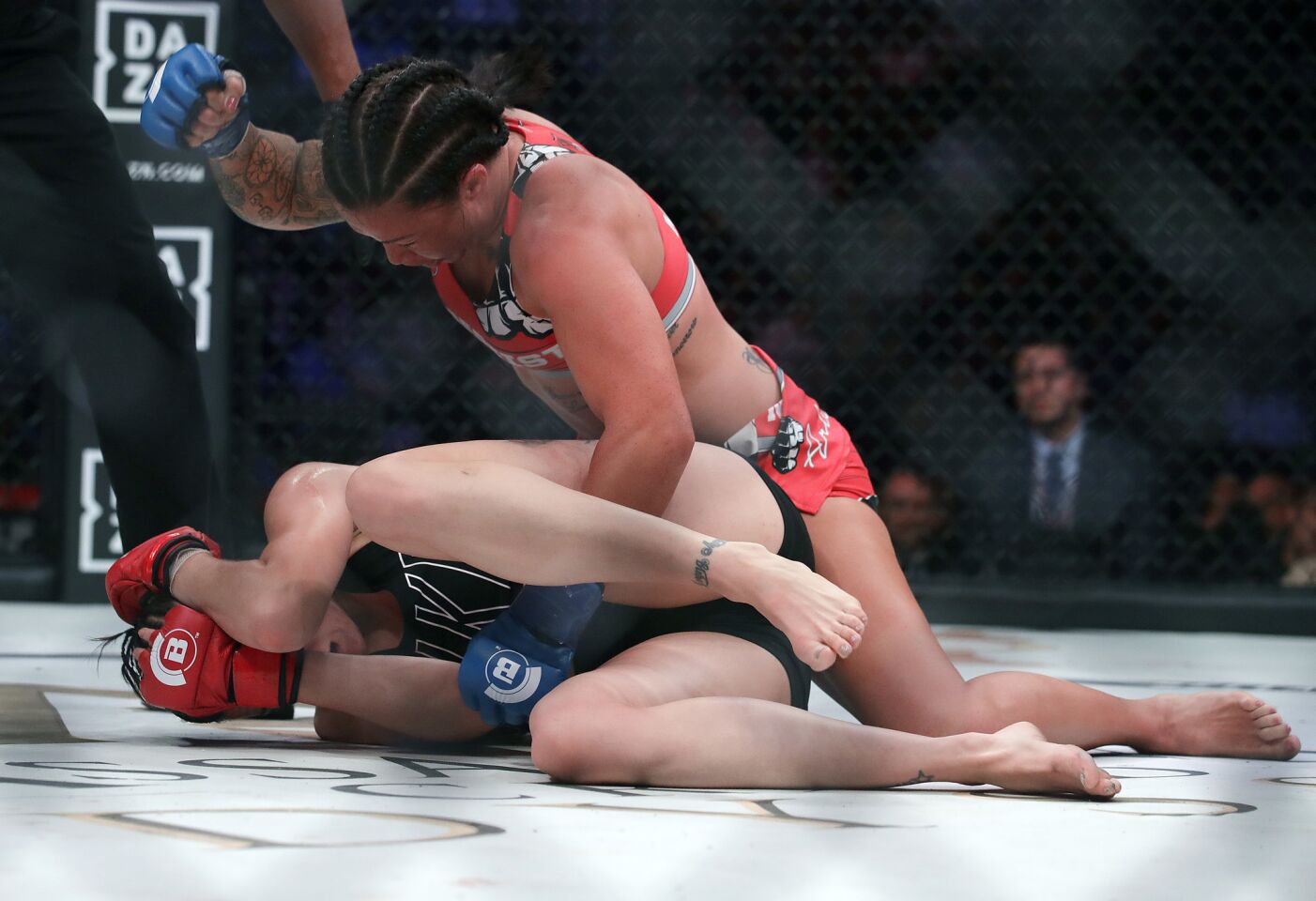 Arlene Blencowe, top, punches Amber Leibrock during a featherweight mixed martial arts fight at Bellator 206 in San Jose, Calif., Saturday, Sept. 29, 2018. Blencowe won by knockout in the third round. (AP Photo/Jeff Chiu)