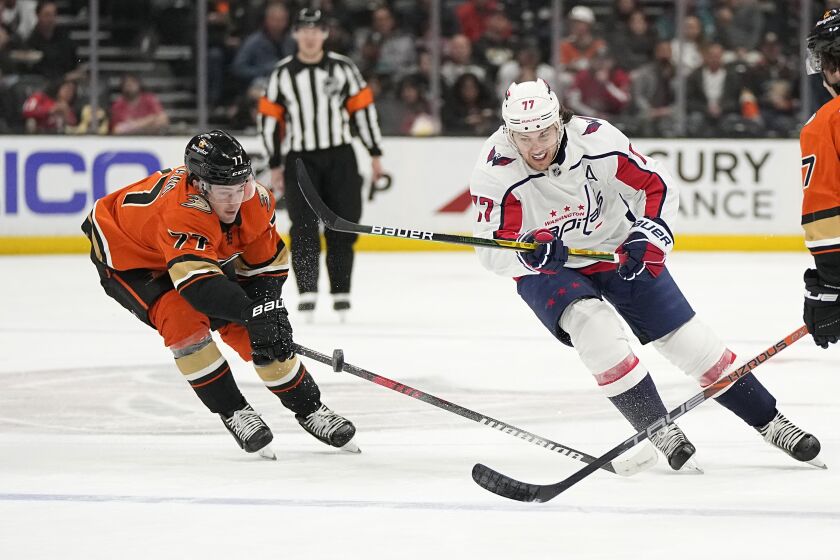 Anaheim Ducks right wing Frank Vatrano, left, and Washington Capitals right wing T.J. Oshie battle for the puck during the second period of an NHL hockey game Wednesday, March 1, 2023, in Anaheim, Calif. (AP Photo/Mark J. Terrill)