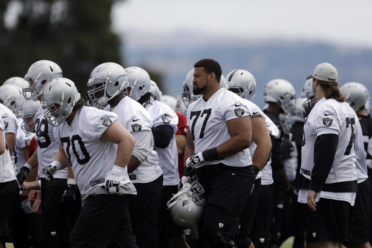 Members of the Oakland Raiders take the field during organized team activities on June 2.