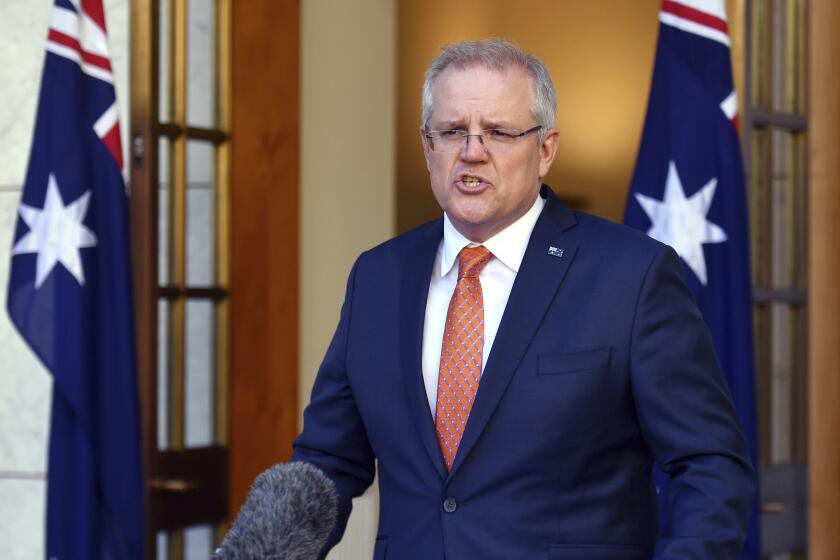 Australian Prime Minister Scott Morrison speaks at a press conference at Parliament House in Canberra, Thursday, July 9, 2020. Australia suspended its extradition treaty with Hong Kong and extended visas for Hong Kong residents in response to China's imposition of a tough national security law on the semi-autonomous territory, the prime minister said. (Mick Tsikas/AAP Image via AP)