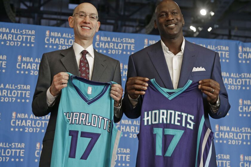 FILE -NBA commissioner Adam Silver, left, and Charlotte Hornets owner Michael Jordan, right, pose for a photo during a news conference to announce Charlotte, N.C., as the site of the 2017 NBA All-Star basketball game, June 23, 2015. Jordan is considering selling the Charlotte Hornets. The six-time NBA champion is in negotiations to sell at least a portion of the franchise to a group that includes Hornets minority owner Gabe Plotkin. (AP Photo/Chuck Burton, File)