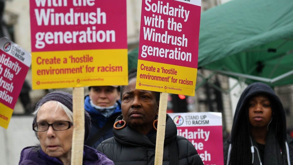 Protesters show their support for the so-called Windrush generation outside the Houses of Parliament in London on Monday.