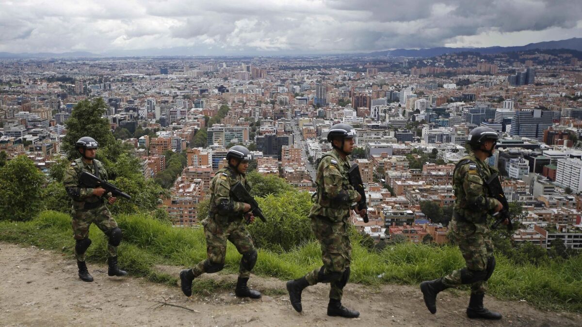 Soldiers patrol the outskirts of Bogota, Colombia, as part of pre-election security, on Saturday. Colombians go to the polls Sunday to elect a new president.