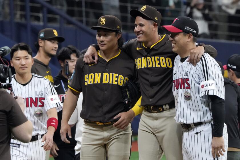 San Diego Padres' designated hitter Manny Machado and Ha-Seong Kim take taproot with players of LG Twins after the exhibition game between the San Diego Padres and LG Twins at the Gocheok Sky Dome in Seoul, South Korea, Monday, March 18, 2024. The Los Angeles Dodgers and the San Diego Padres will meet in a two-game series on March 20th-21st in Seoul for the MLB World Tour Seoul Series. Padres won 5-4. (AP Photo/Lee Jin-man)