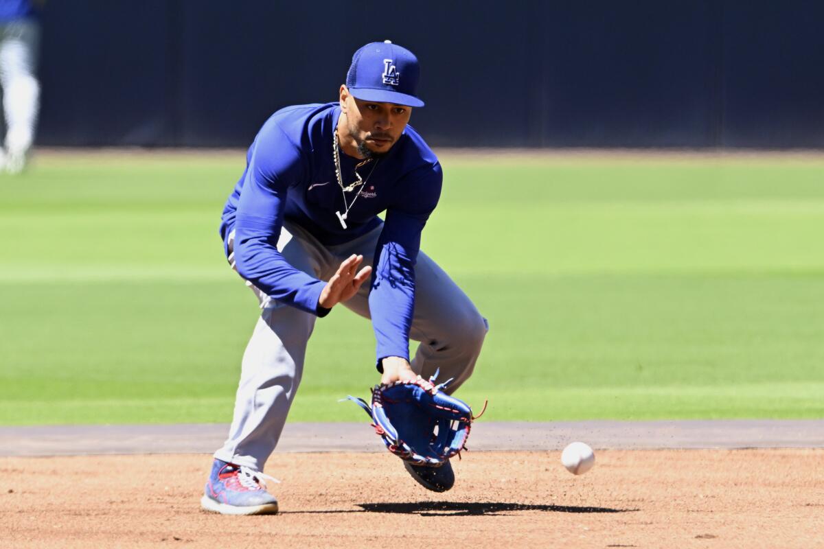 Los Angeles Dodgers' Mookie Betts fields a ground ball during warmups before a baseball game.