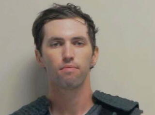 A mugshot of Tyler Robinson.