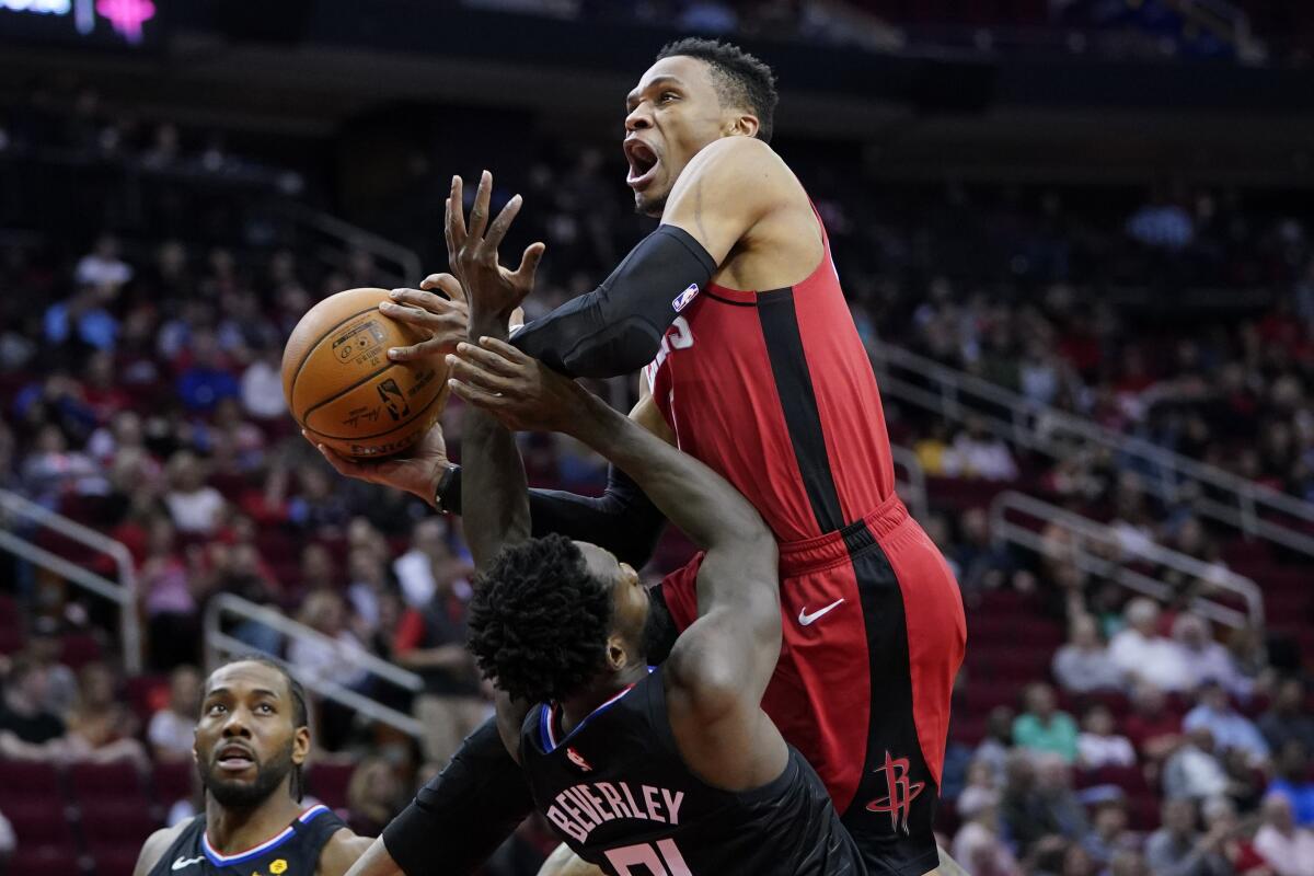 Rockets guard Russell Westbrook is fouled by Clippers guard Patrick Beverley during the second half of a game March 5 in Houston at the Toyota Center.