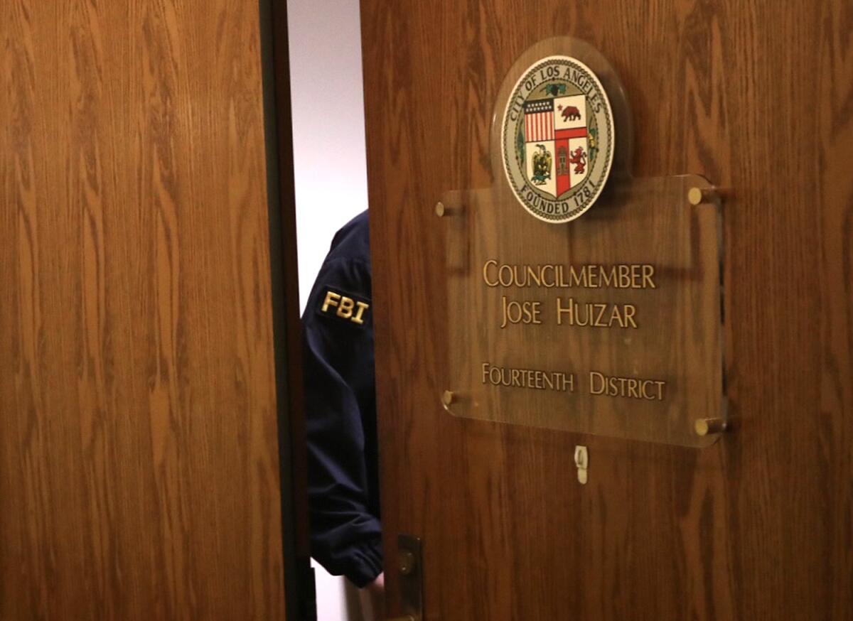 An FBI agent searching the City Hall office of Jose Huizar, then a Los Angeles city councilman, in 2018.