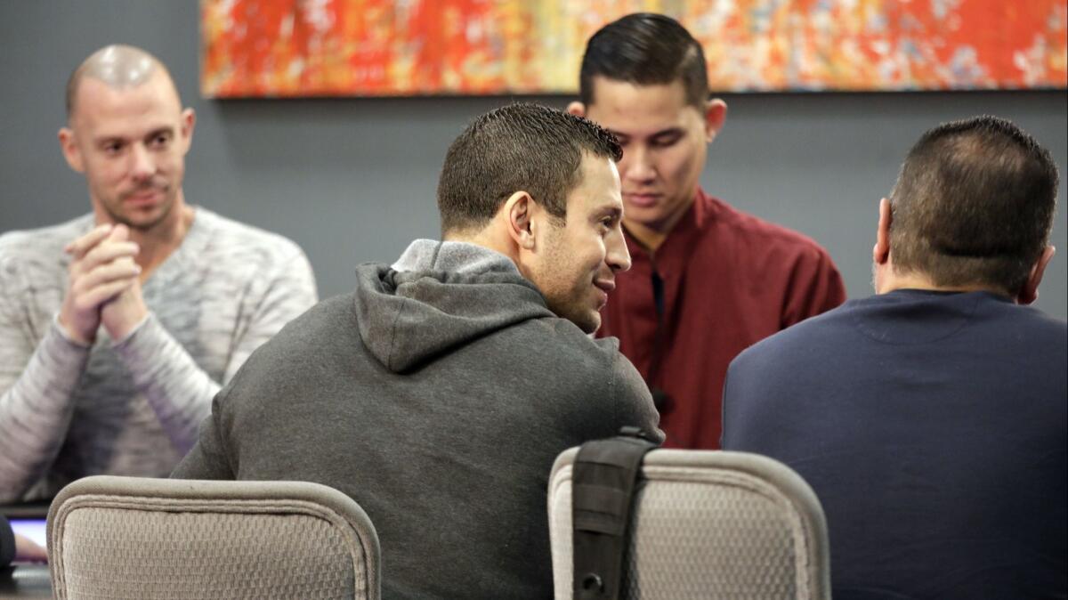 Garrett Adelstein, center, shares stories with Nick Vertucci, far right, during the "Live at the Bike" poker cash game at the Bicycle Casino in Bell Gardens. Matt Berkey, left, listens in.