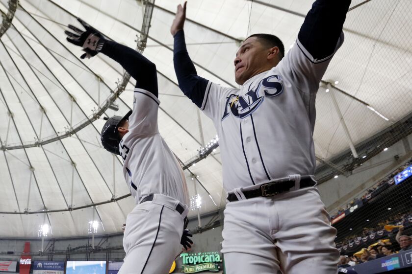 ST. PETERSBURG, FL - OCTOBER 07: Willy Adames #1 of the Tampa Bay Rays is greeted by teammate Avisail Garcia #24 after hitting a solo home run in the sixth inning during Game 3 of the ALDS between the Houston Astros and the Tampa Bay Rays at Tropicana Field on Monday, October 7, 2019 in St. Petersburg, Florida. (Photo by Mike Carlson/MLB Photos via Getty Images)